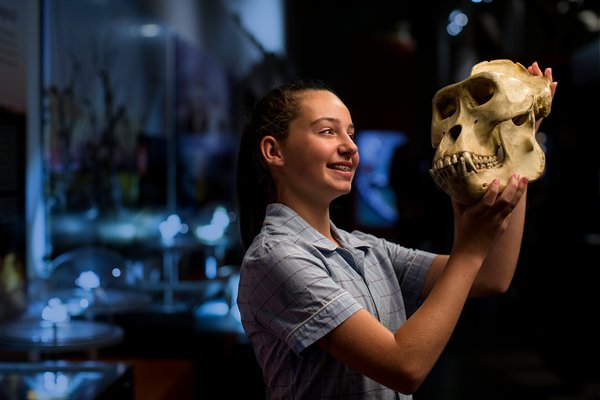 School girl looking at a skull