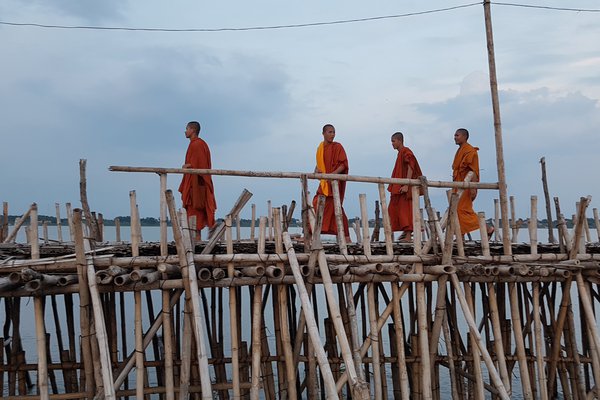 Monks on bamboo bridge